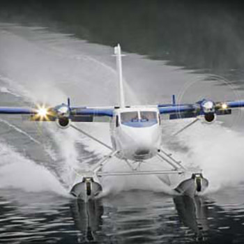 Amphibious Twin Otter aircraft landing on water