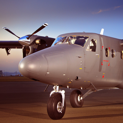 A grey Twin Otter Guardian aircraft on the runway