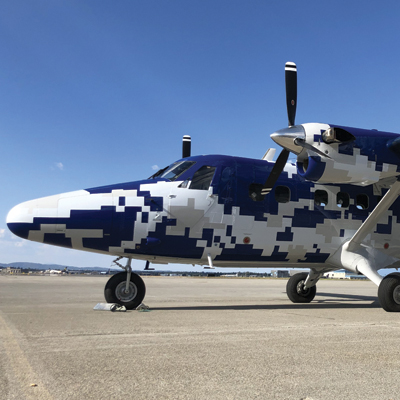 A camouflage Twin Otter Guardian aircraft on the runway