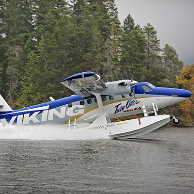 Amphibious Twin Otter aircraft landing on water