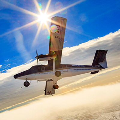 Twin Otter aircraft in flight above clouds