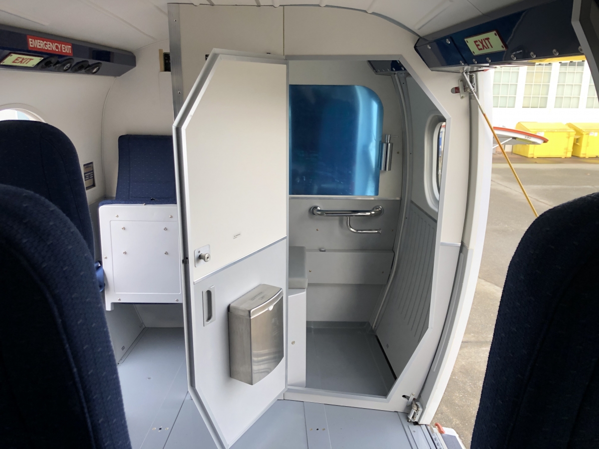 An open lavatory door showing Twin Otter lavatory