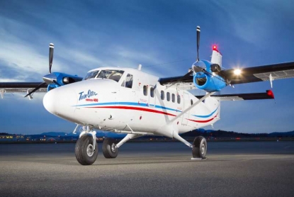 A white Twin Otter Series 400 aircraft on the runway