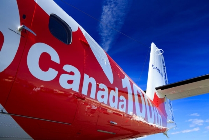 'Canada 100th' logo on fuselage of aircraft